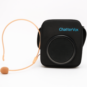 A black ChatterVox portable voice amplifier with a speaker on the front and a beige headset microphone placed beside it, set against a white background.